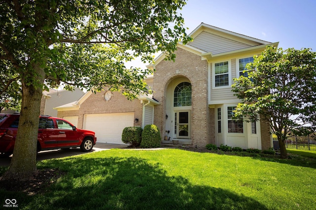 11727 Wedgeport Ln, Fishers, IN 46037 - traditional home featuring brick siding, an attached garage, a front lawn, and driveway
