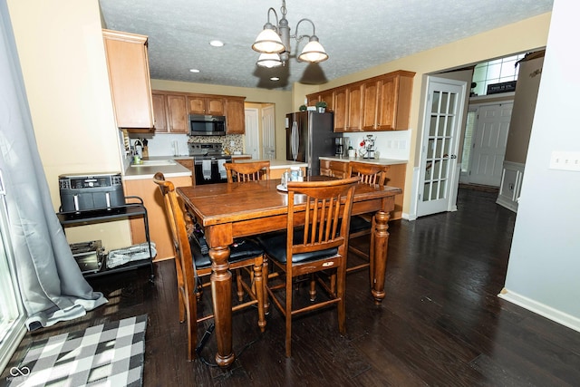 11727 Wedgeport Ln, Fishers, IN 46037 - dining space featuring a chandelier, dark wood finished floors, a textured ceiling, recessed lighting, and baseboards