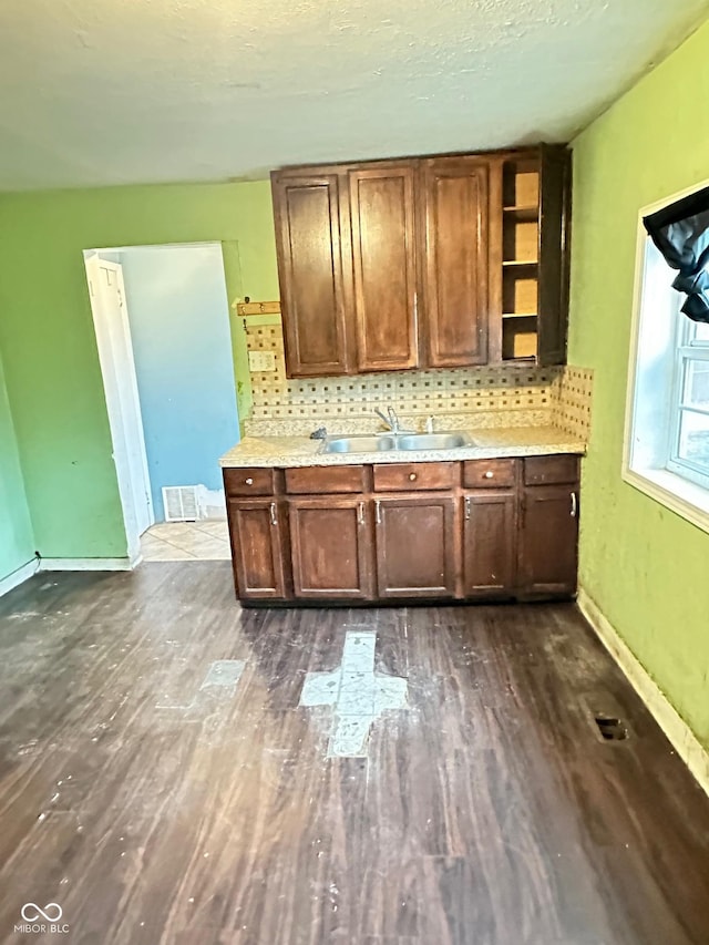 834 N Temple Ave, Indianapolis, IN 46201 - kitchen with a sink, dark wood-type flooring, open shelves, backsplash, and light countertops