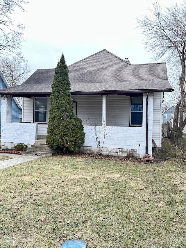 834 N Temple Ave, Indianapolis, IN 46201 - view of front of property with a front lawn, a shingled roof, and covered porch