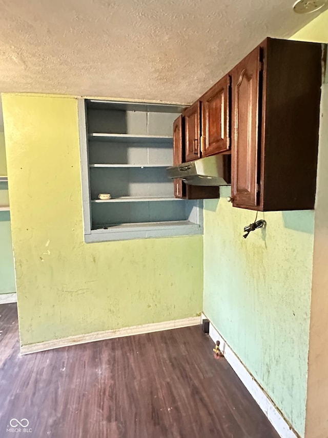 834 N Temple Ave, Indianapolis, IN 46201 - kitchen view of under cabinet range hood, dark wood finished floors, a textured ceiling, and baseboards