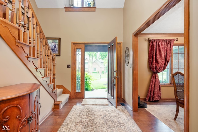 6575 Robin Hood Dr, Indianapolis, IN 46227 - entryway featuring wood finished floors, a towering ceiling, stairs, and baseboards