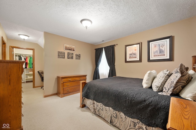 6575 Robin Hood Dr, Indianapolis, IN 46227 - bedroom featuring light carpet, a spacious closet, a textured ceiling, a closet, and baseboards