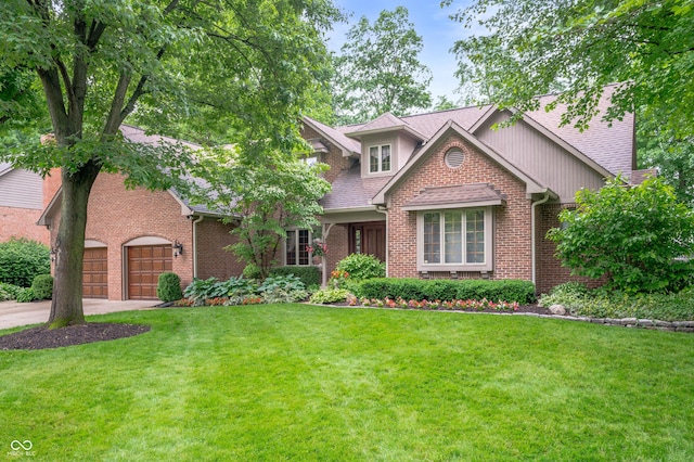 6575 Robin Hood Dr, Indianapolis, IN 46227 - view of front of property with a front lawn, driveway, brick siding, a garage, and roof with shingles