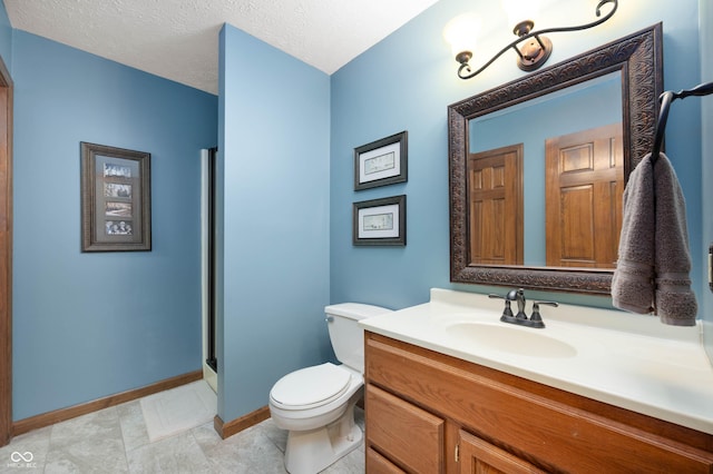 6575 Robin Hood Dr, Indianapolis, IN 46227 - bathroom featuring vanity, toilet, baseboards, and a stall shower