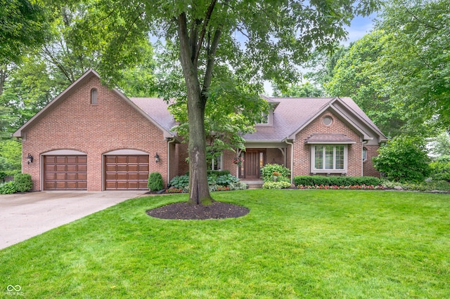 6575 Robin Hood Dr, Indianapolis, IN 46227 - traditional-style house featuring brick siding, driveway, a garage, and a front lawn