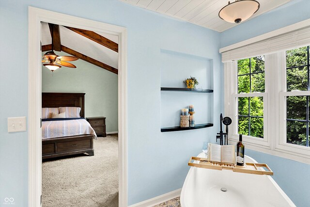 bathroom featuring ceiling fan, baseboards, and vaulted ceiling