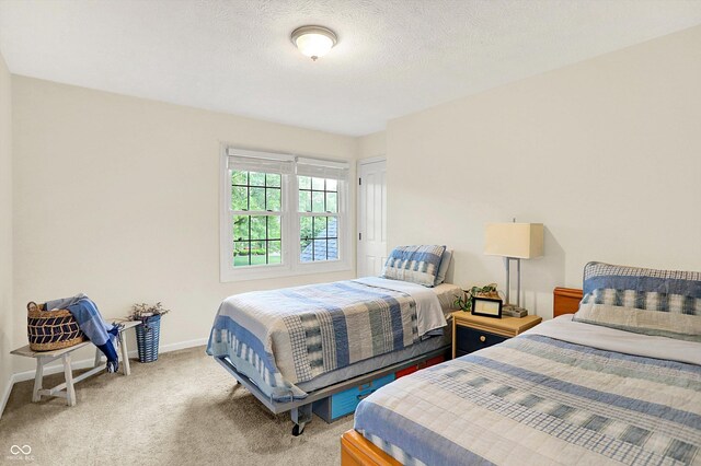 carpeted bedroom featuring baseboards