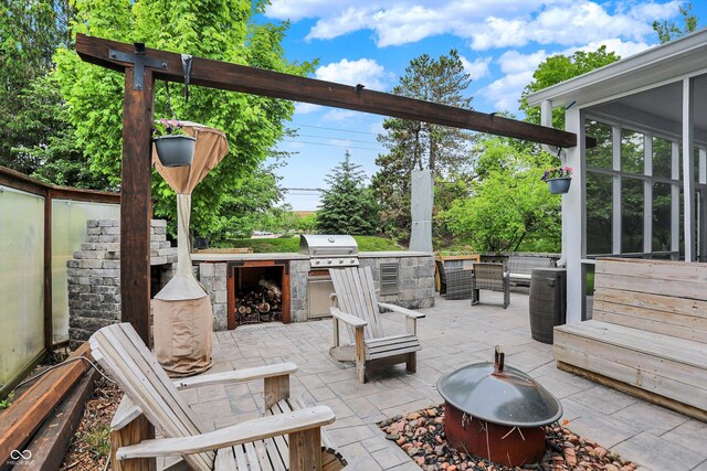 view of patio featuring a fire pit and exterior kitchen