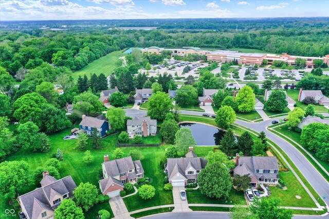 aerial overview of property's location featuring a forest and nearby suburban area