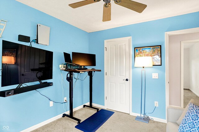workout area with carpet, a ceiling fan, and baseboards