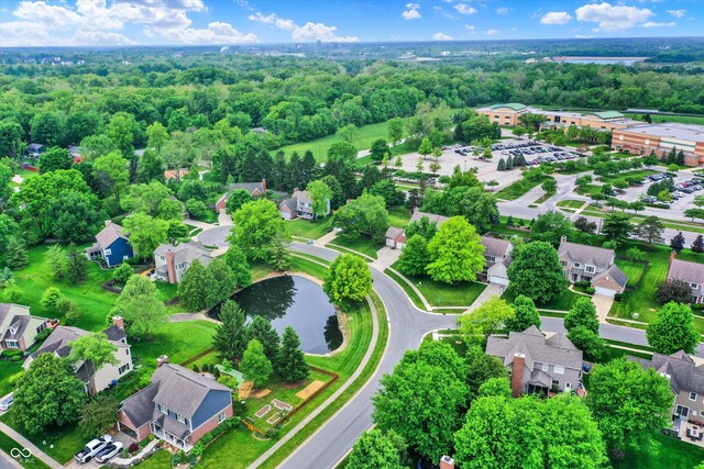aerial view of property and surrounding area with nearby suburban area and a nearby body of water