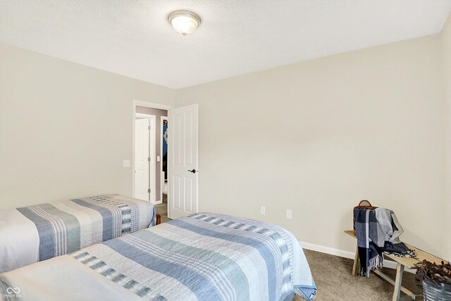 carpeted bedroom with baseboards