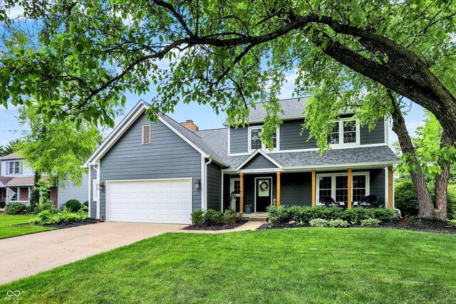 view of front facade featuring covered porch, a garage, and a front lawn