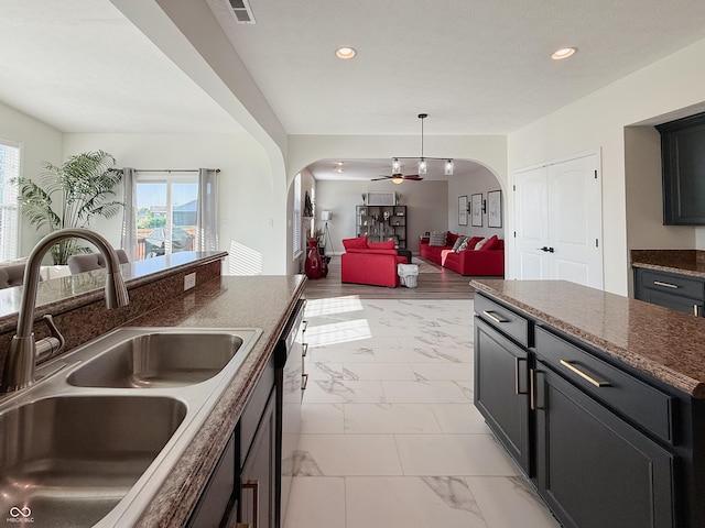 8644 N Deer Crossing Blvd, Mccordsville, IN 46055 - kitchen featuring a sink, arched walkways, light marble finish floors, open floor plan, and recessed lighting