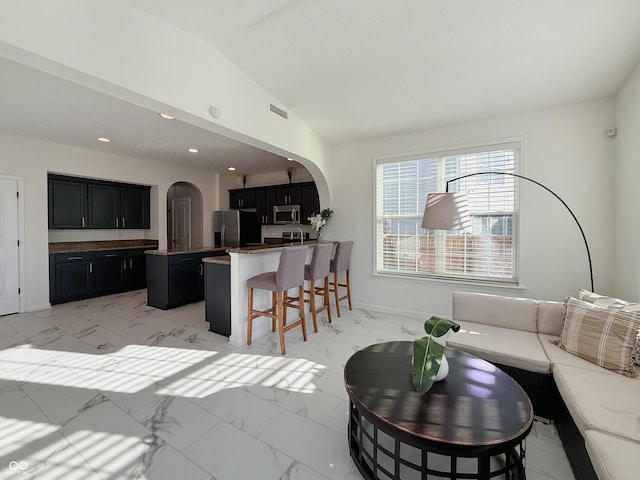 8644 N Deer Crossing Blvd, Mccordsville, IN 46055 - living room featuring arched walkways, light marble finish floors, lofted ceiling, and recessed lighting