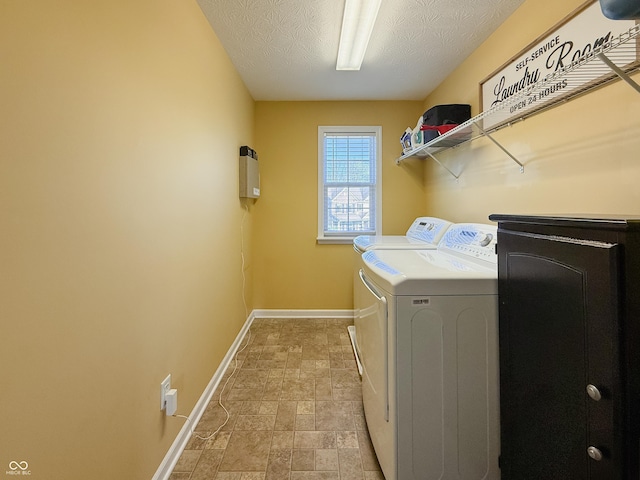 8644 N Deer Crossing Blvd, Mccordsville, IN 46055 - clothes washing area with baseboards, washer and clothes dryer, stone finish floors, and a textured ceiling
