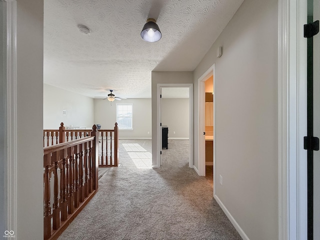 8644 N Deer Crossing Blvd, Mccordsville, IN 46055 - corridor with carpet, an upstairs landing, baseboards, and a textured ceiling