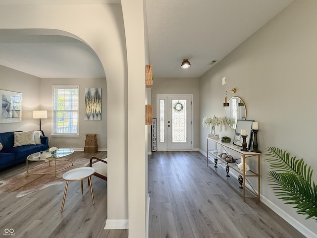8644 N Deer Crossing Blvd, Mccordsville, IN 46055 - entrance foyer with wood finished floors, plenty of natural light, baseboards, and arched walkways