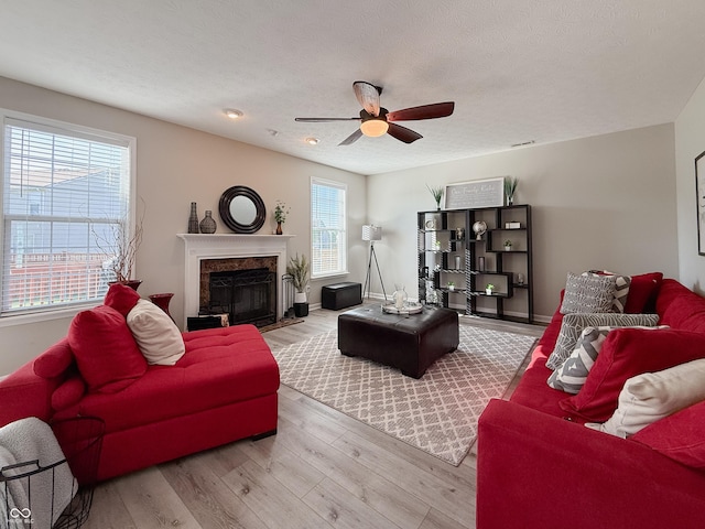 8644 N Deer Crossing Blvd, Mccordsville, IN 46055 - living area featuring a ceiling fan, wood finished floors, a premium fireplace, baseboards, and a textured ceiling