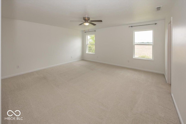 spare room featuring ceiling fan and baseboards