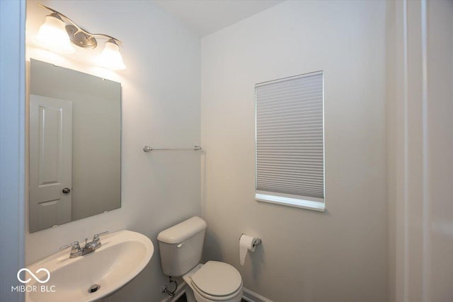 half bath featuring a sink and toilet