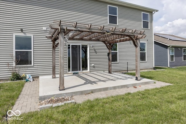 rear view of house with a lawn, a pergola, and a patio