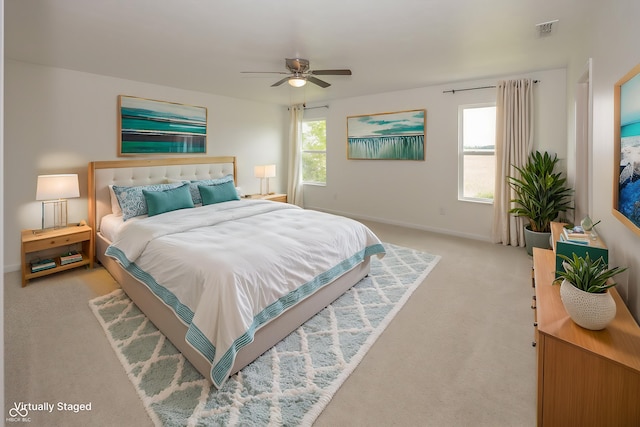 bedroom featuring light carpet, baseboards, and a ceiling fan