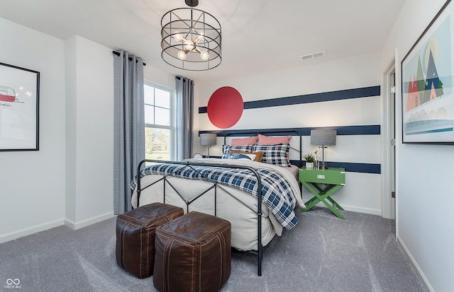 carpeted bedroom with a chandelier and baseboards