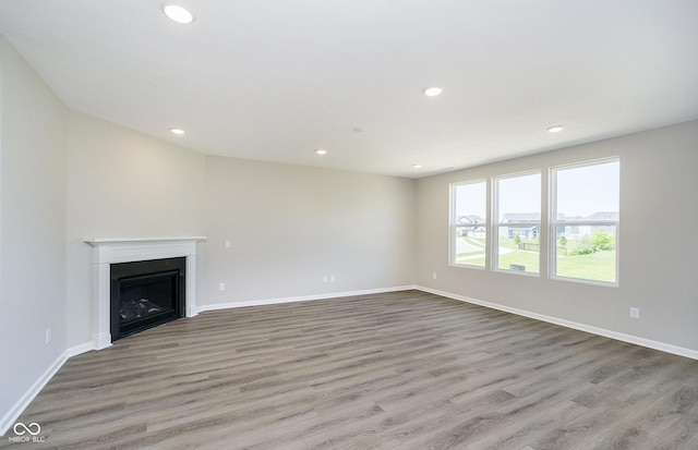 3256 Fawn Cir, Brownsburg, IN 46112 - unfurnished living room with wood finished floors, recessed lighting, a fireplace, and baseboards