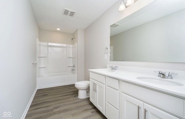 3256 Fawn Cir, Brownsburg, IN 46112 - bathroom with double vanity, toilet, wood finished floors, shower / bathtub combination, and recessed lighting
