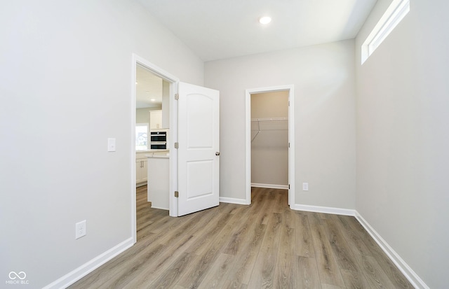 3256 Fawn Cir, Brownsburg, IN 46112 - unfurnished bedroom with light wood-style floors, a spacious closet, baseboards, a closet, and recessed lighting