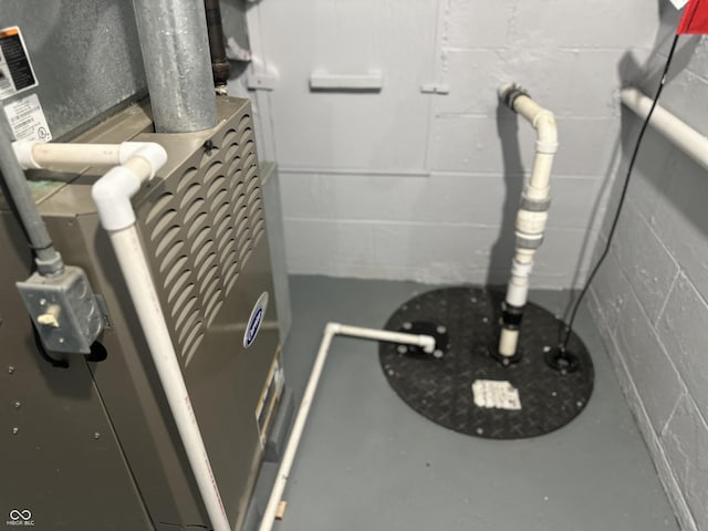 8417 S Sherman Dr, Indianapolis, IN 46237 - detailed view of concrete block wall, finished concrete flooring, and heating unit