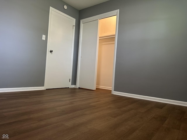 8417 S Sherman Dr, Indianapolis, IN 46237 - unfurnished bedroom featuring dark wood-type flooring, baseboards, and a closet