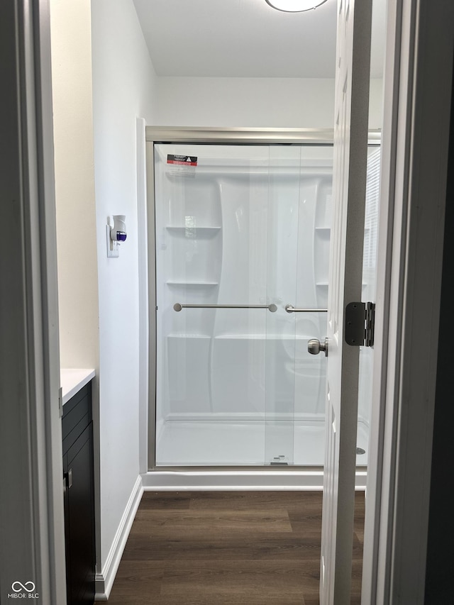 8417 S Sherman Dr, Indianapolis, IN 46237 - bathroom with wood finished floors, vanity, a shower stall, and baseboards