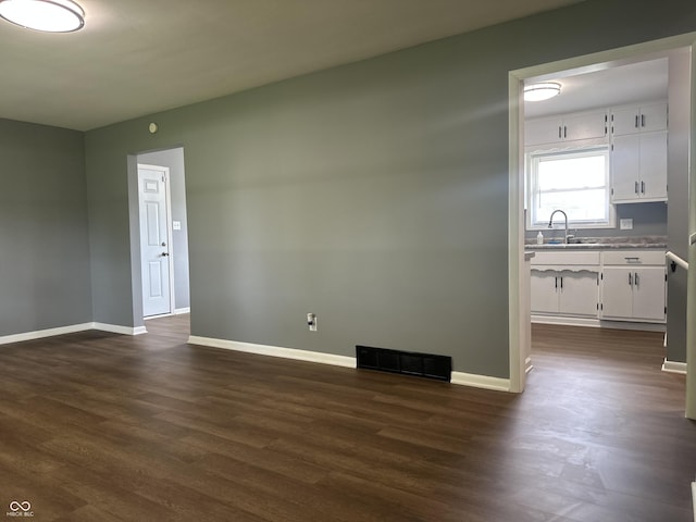 8417 S Sherman Dr, Indianapolis, IN 46237 - unfurnished living room with a sink, baseboards, and dark wood finished floors