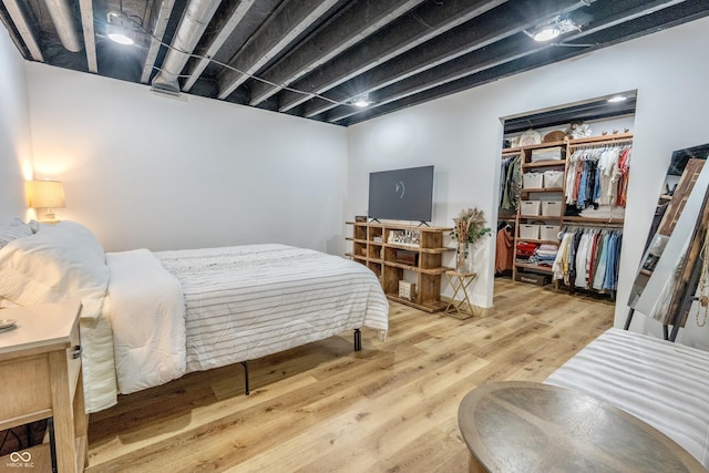 bedroom with a closet and wood finished floors