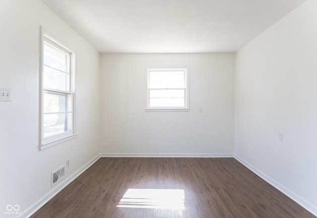 370 N Bazil Ave, Indianapolis, IN 46219 - empty room featuring plenty of natural light, dark wood-style flooring, and baseboards