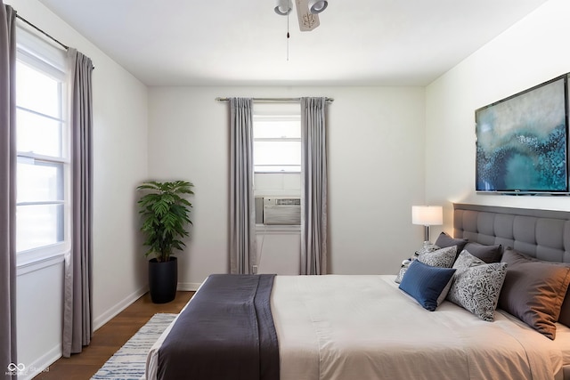 370 N Bazil Ave, Indianapolis, IN 46219 - bedroom with wood finished floors, multiple windows, cooling unit, and baseboards