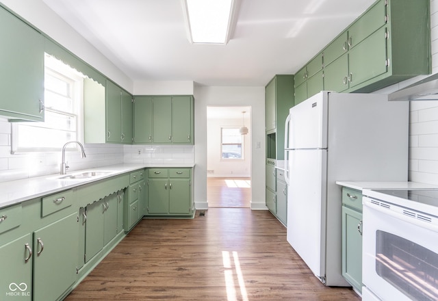 370 N Bazil Ave, Indianapolis, IN 46219 - kitchen with white range with electric stovetop, a sink, backsplash, dark wood-style flooring, and light countertops