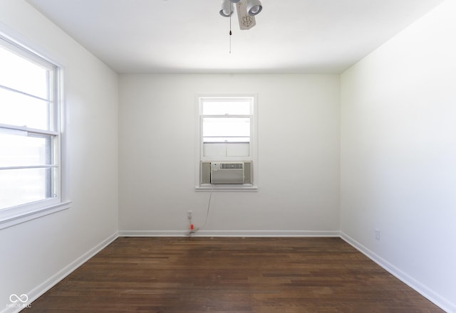 370 N Bazil Ave, Indianapolis, IN 46219 - empty room featuring cooling unit, dark wood-type flooring, and baseboards