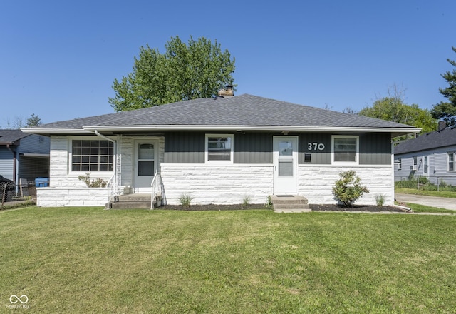 370 N Bazil Ave, Indianapolis, IN 46219 - view of front of house with entry steps, stone siding, and a front yard