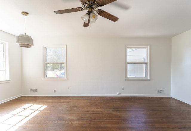 370 N Bazil Ave, Indianapolis, IN 46219 - spare room with plenty of natural light, dark wood-style flooring, ceiling fan, and baseboards
