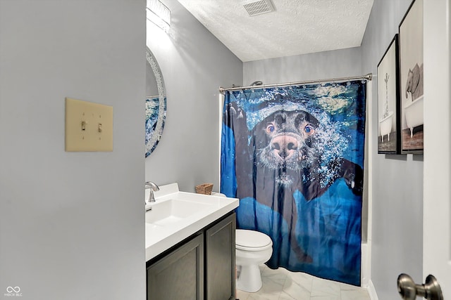 full bathroom with marble finish floors, toilet, a textured ceiling, and vanity