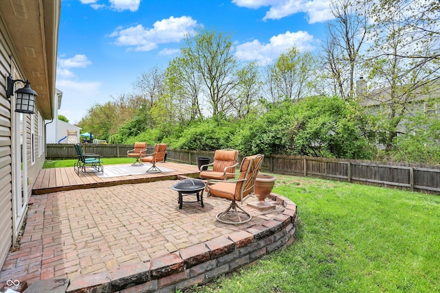 view of patio / terrace with an outdoor fire pit and a wooden deck