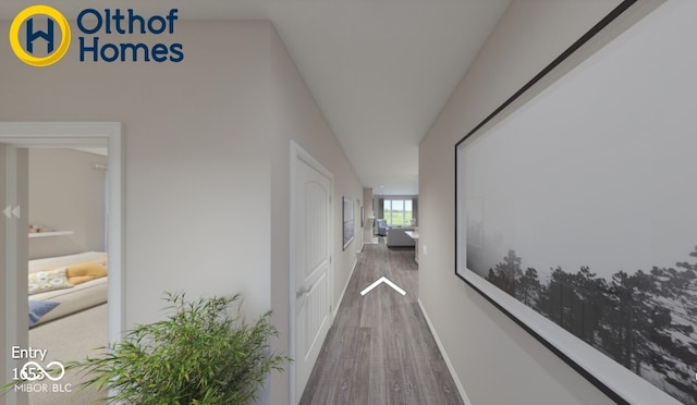 corridor featuring wood finished floors and baseboards