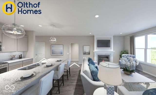living area with dark wood finished floors, baseboards, recessed lighting, and a glass covered fireplace