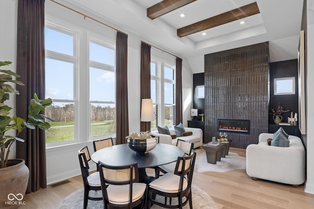 9602 Fall Creek Rd, Indianapolis, IN 46256 - dining space featuring light wood-style flooring, a large fireplace, baseboards, recessed lighting, and beamed ceiling