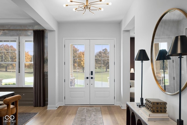 9602 Fall Creek Rd, Indianapolis, IN 46256 - entrance foyer featuring french doors, light wood-type flooring, plenty of natural light, and a chandelier