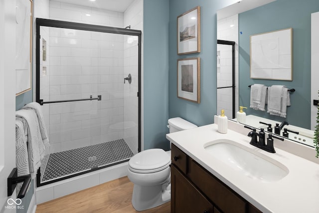 9602 Fall Creek Rd, Indianapolis, IN 46256 - full bath featuring toilet, a stall shower, wood finished floors, and vanity